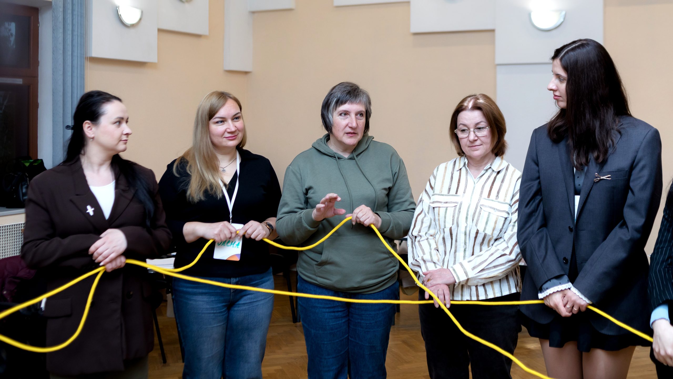 participants of workshop holding a yellow rope